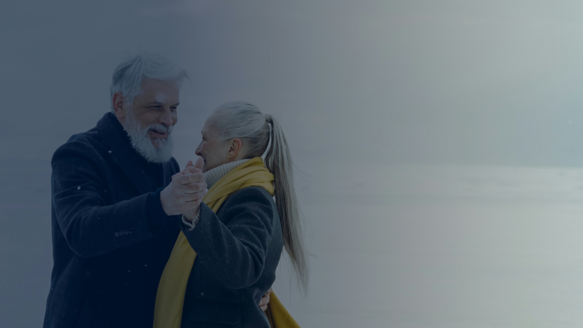 Elderly couple dancing on snow-covered ground