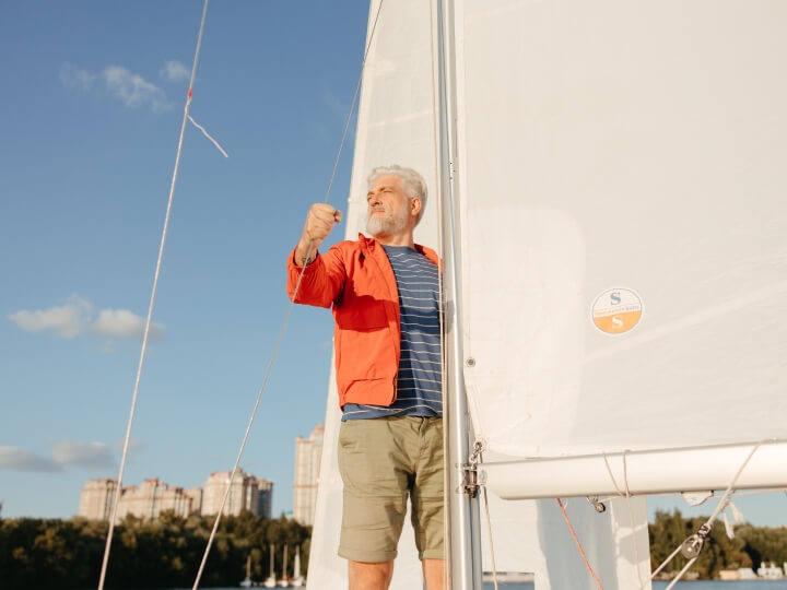 Man with triumphant expression on sailboat